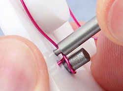 Peg being removed from wire jig